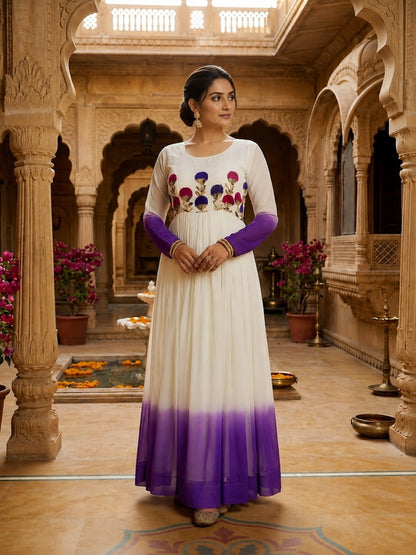 Woman in a traditional outfit standing in an ornate indoor setting with floral decorations.