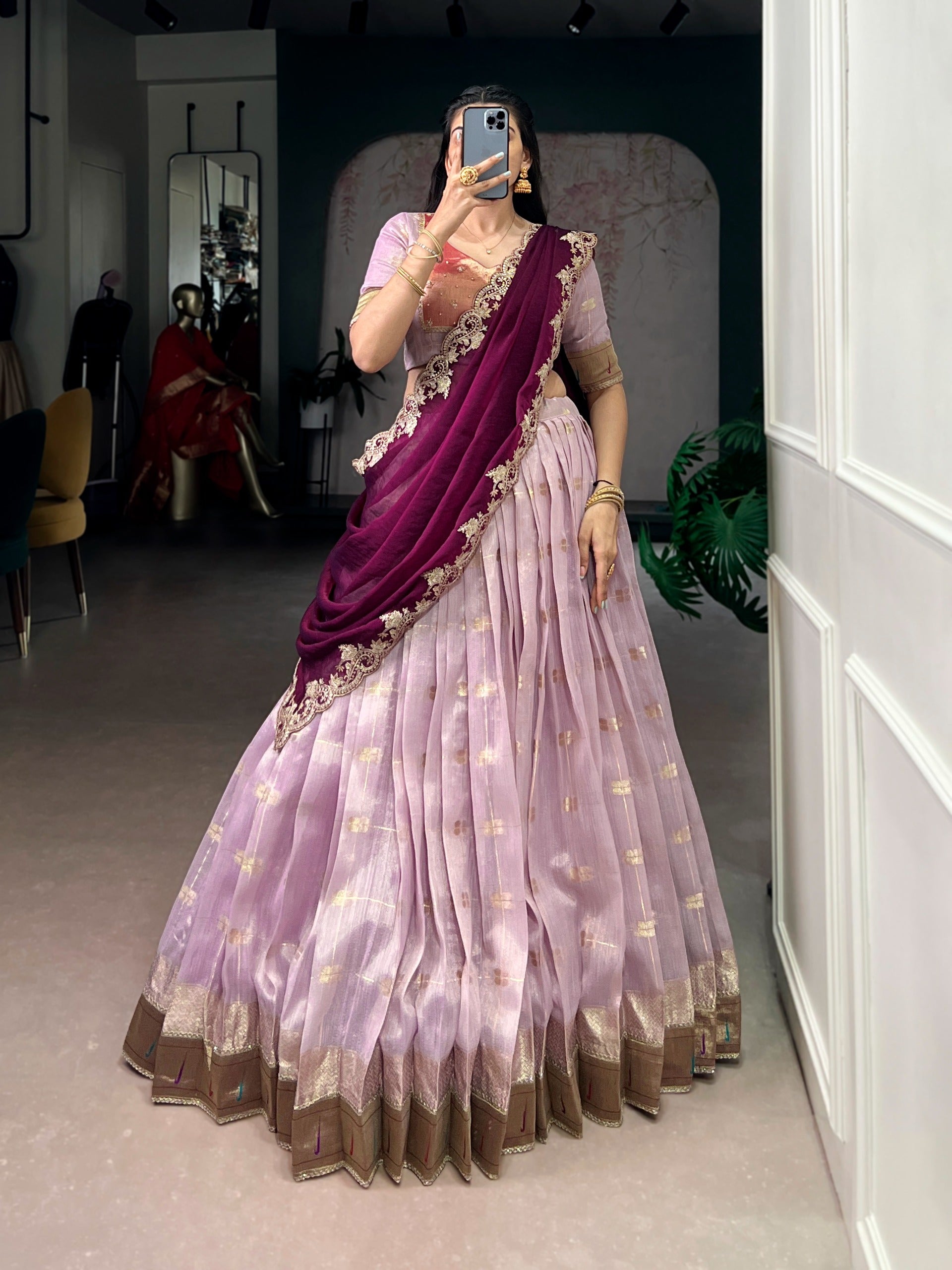 Woman wearing a pink saree with a purple blouse 